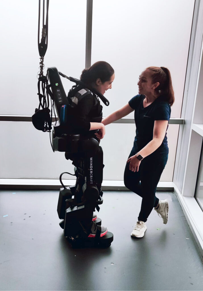 Esther and a Wandercraft therapist during a walking session.